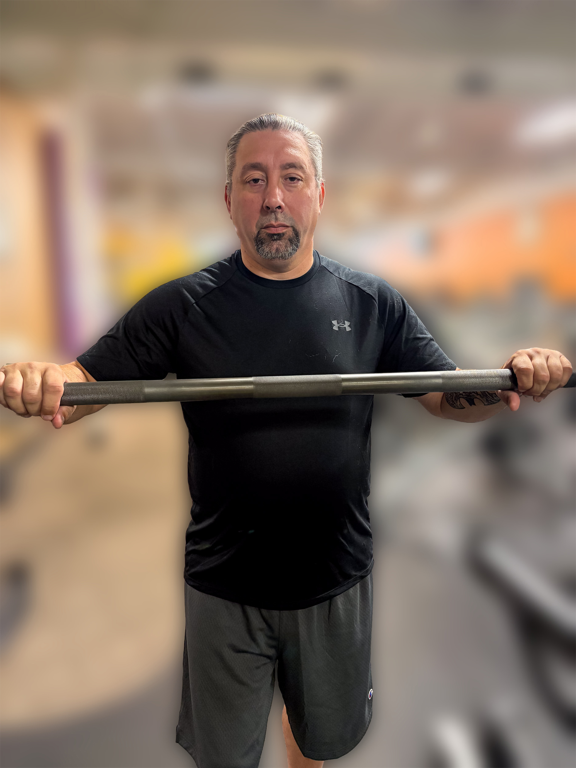 Lewis Mendez holding a barbell in a gym