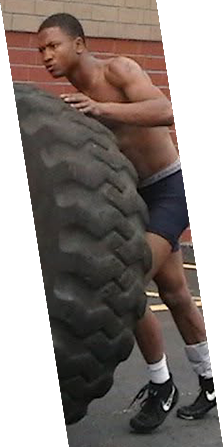 Athlete performing a tire flip during conditioning training