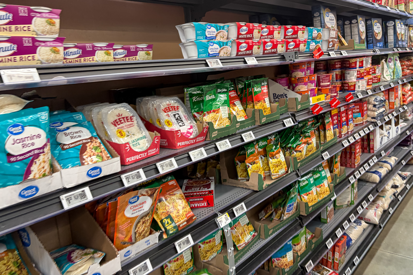 Rice and other carbohydrate options displayed in a grocery store aisle
