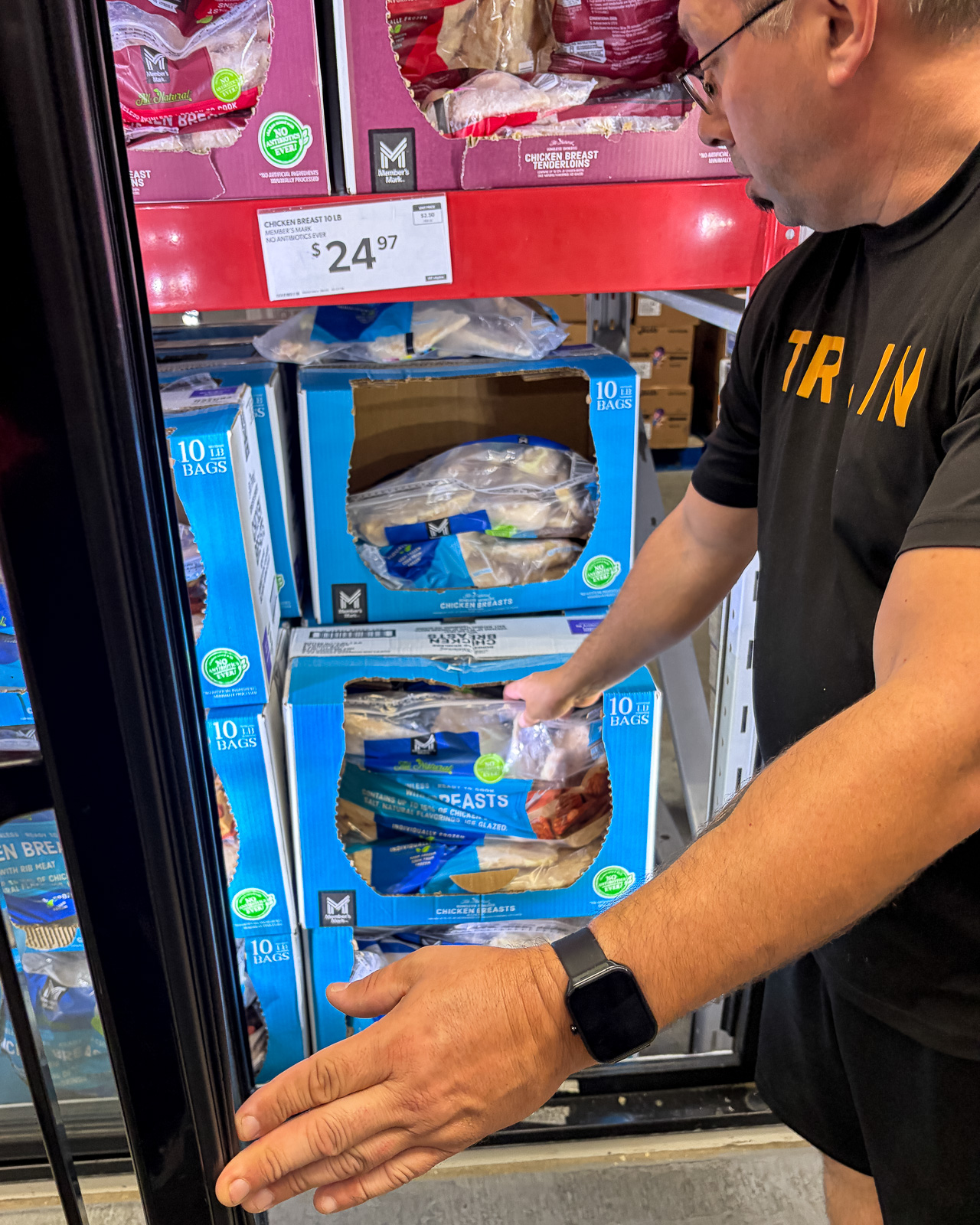 Lewis Mendez selecting chicken breast as a protein option while grocery shopping